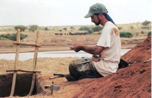 Taking notes in Tsavo, Kenya with buffalo at the Galana River